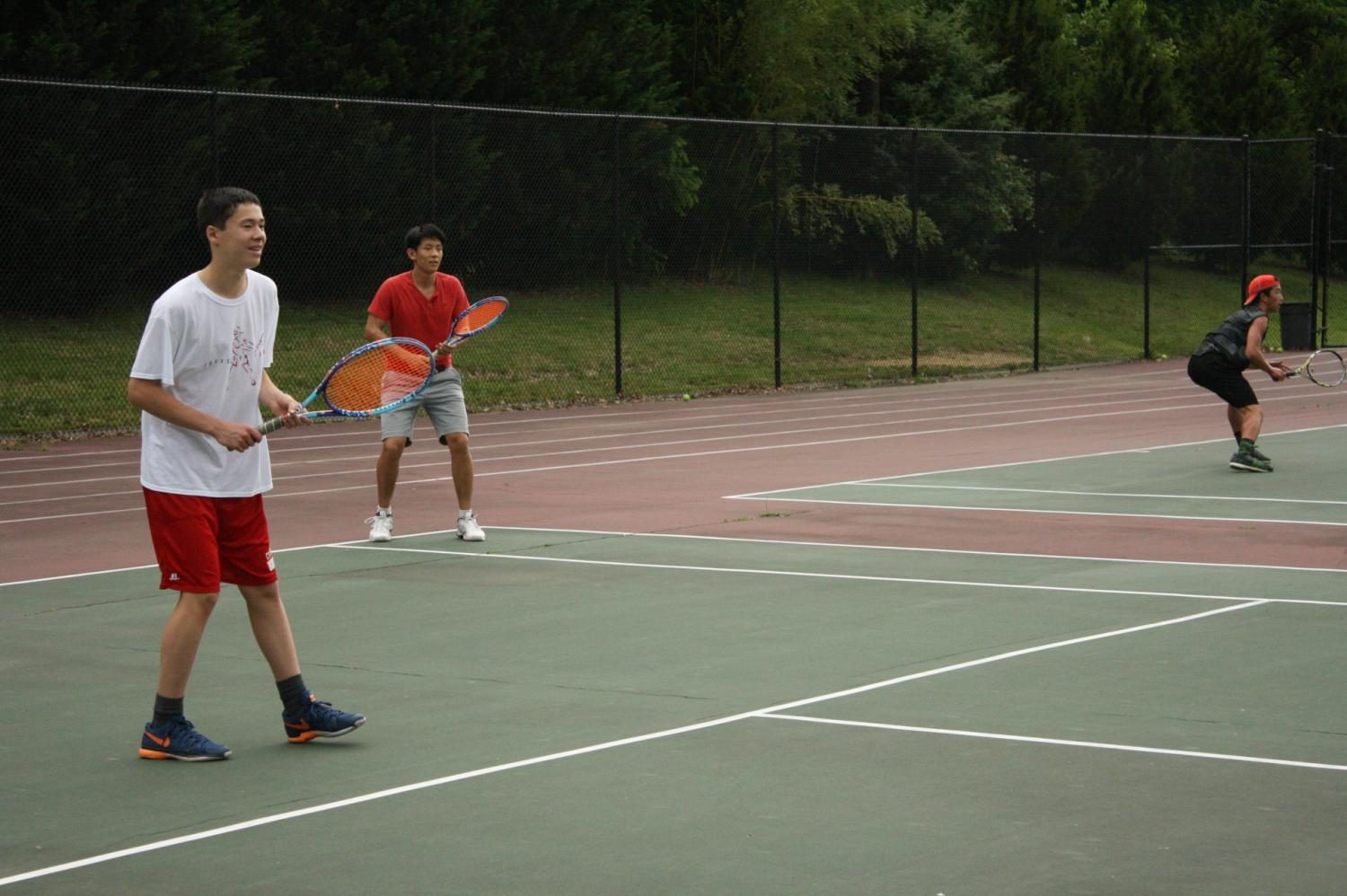 Freshman William Vroom and Senior Ruyan Zhang practice ahead of the state championship. Hard work and practice makes quality tennis players who can win championships.