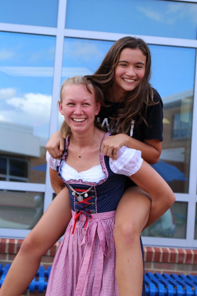 Sophomore Eva Decesare and German exchange student Emily spend their time in Oktoberfest sharing smiles and giving piggy-back rides.