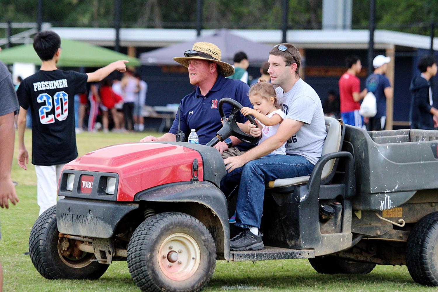 David Gardzel and Clint Behling drive around the Back-to-School Bash with Behling's daughter.