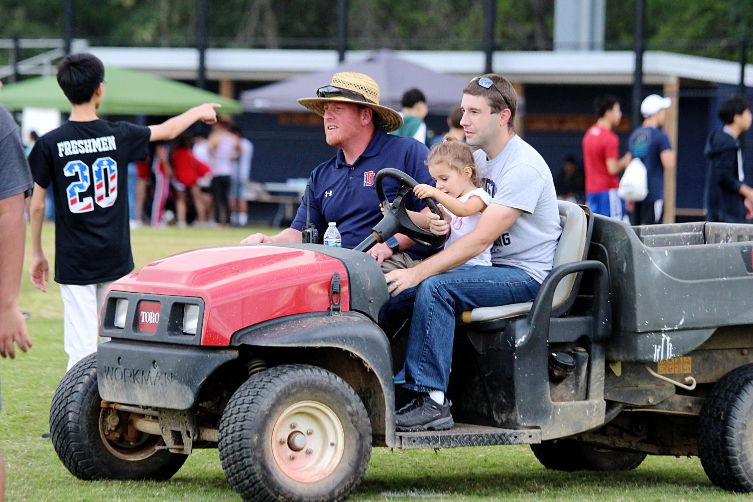 David Gardzel and Clint Behling drive around the Back-to-School Bash with Behlings daughter.