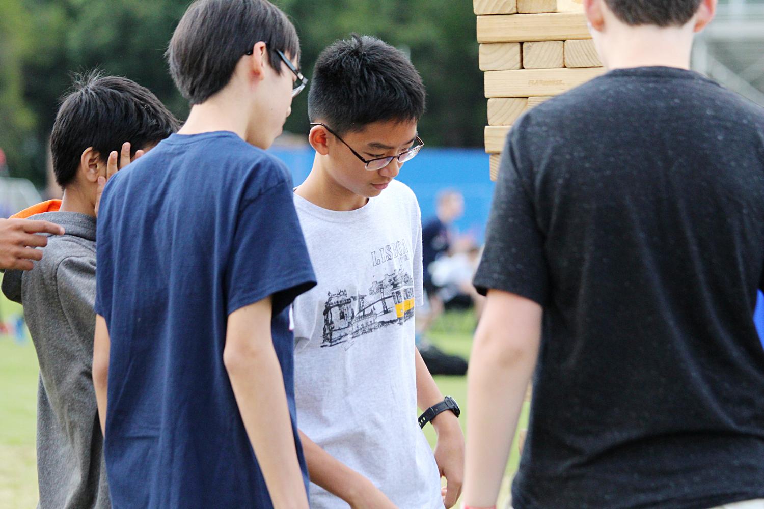 Sophomore Joshua Gong carefully eyes the Jenga structure before his next move.