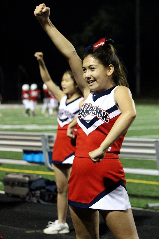 Junior Julia Martinez strikes a pose in the middle of a cheerleading routine.