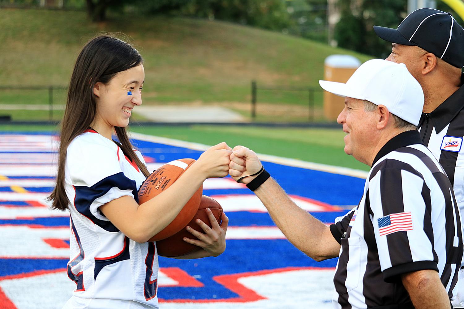 Senior Victoria Chuah fists bump one of the referees prior to the start of the game.