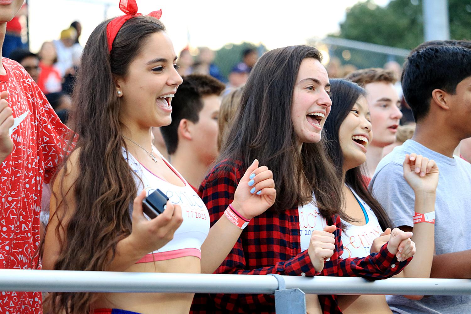 From left to right: Seniors Artemis Veizi, Mara Casebeer, and Jessica Ly cheer on the football team from the stadium.