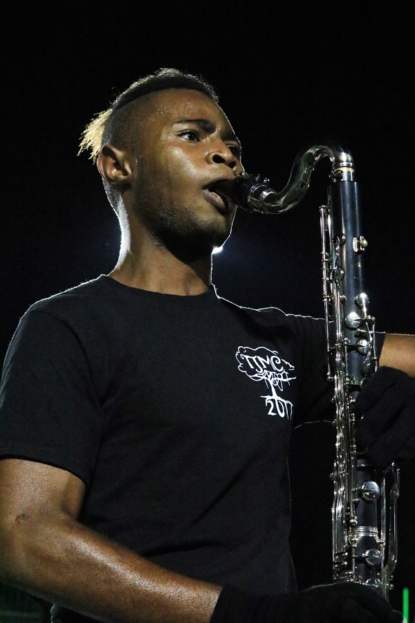 Senior Ik Ogbonna plays a bass clarinet as the marching band performance comes to an end.
