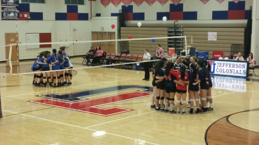 Teams from both sides huddle on their respective sides of the court to discuss plays for the next half of the game.