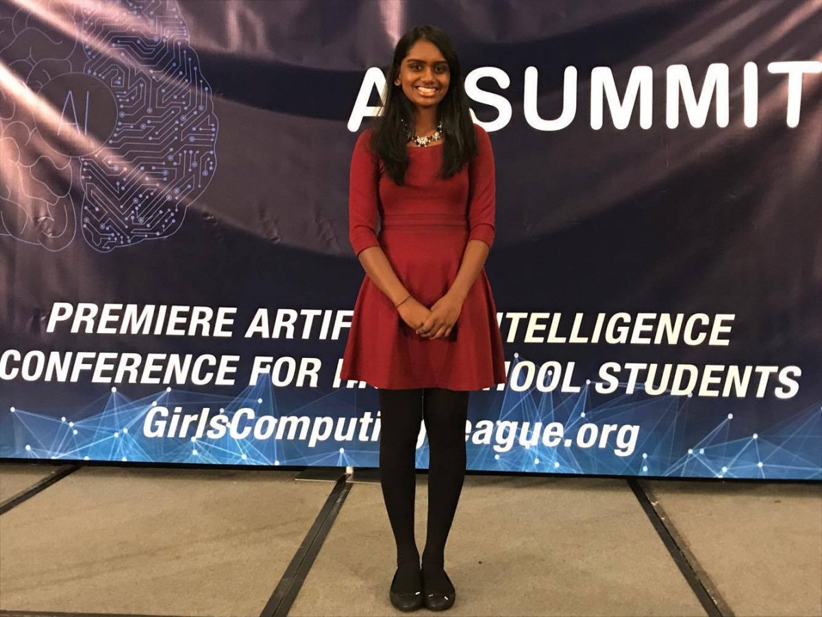 Kopparapu smiles as she stands on stage.
