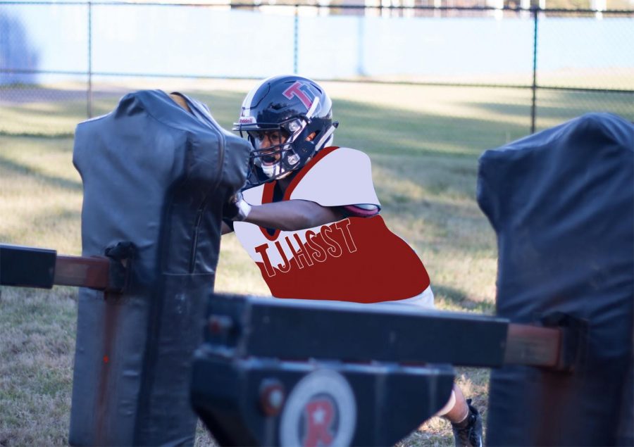 Memon pushes against a locked blocking sled for a sled drill. Football players practice sled drills to increase power and speed. 