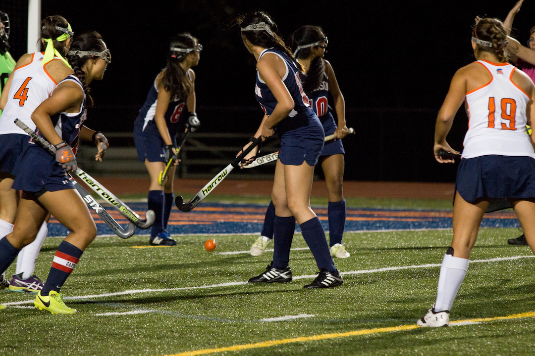Players listen to a referee's call.