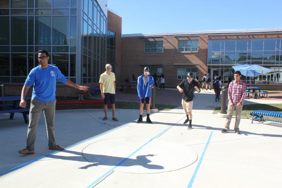 Junior Vikrant Magadi prepares people for a swimming contest before asking junior Kaitlin Phan.