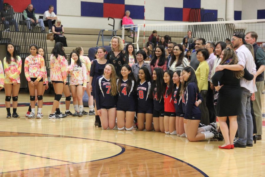 Seniors of the varsity team and their parents pose for pictures before the game begins.