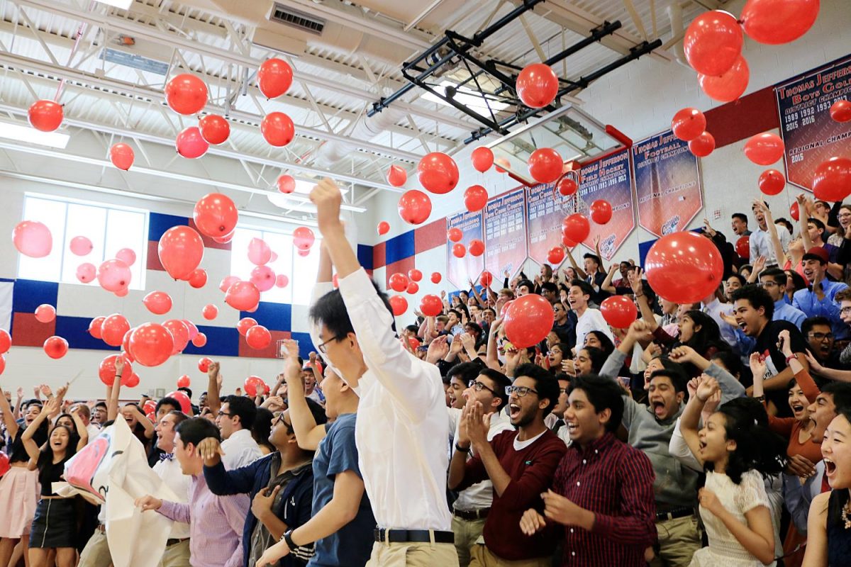 Seniors toss red balloons into the air at the end of their "IT"-themed roll call during the Oct. 5 pep rally.