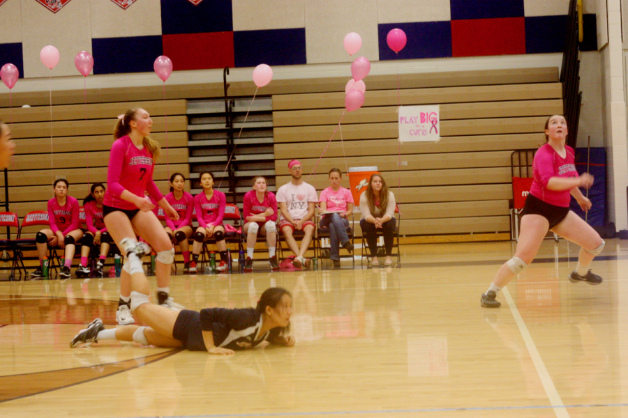 The team goes low to ground a ball in the opposing teams court.