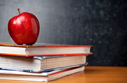 An apple and books on top of a desk. Photo courtesy of Imgur user neappleseed.