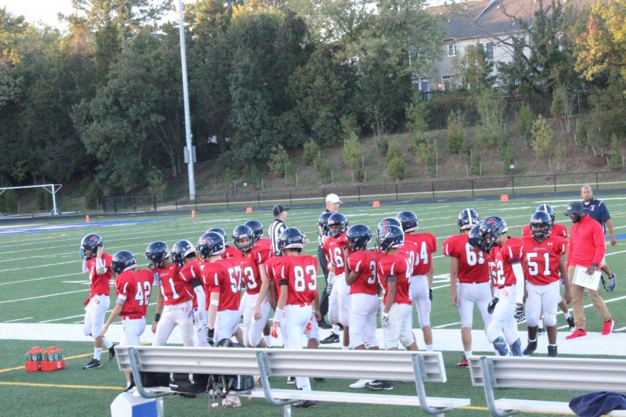 The+JV+football+team+meets+up+before+the+start+of+the+game+against+JEB+Stuart+on+Oct.+19.+