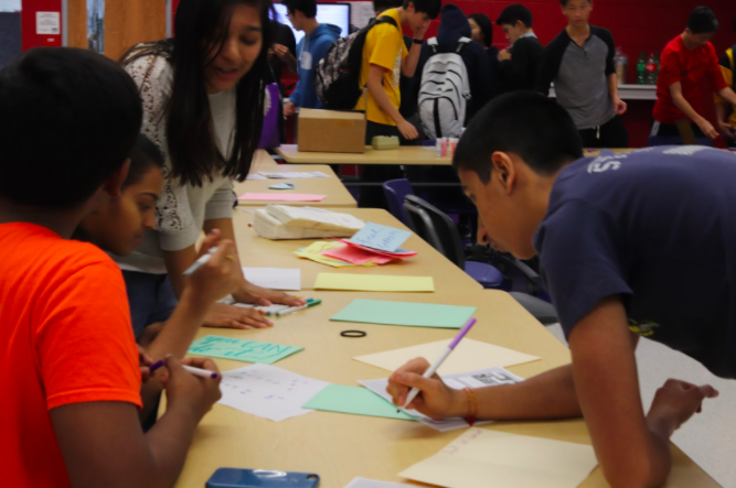 Relay for Life sophomores Manu Onteeru, Monica Saraf, Medha Gupta, and Pranav Wadhwa work on cards to send to cancer patients with the American Cancer Society at the Relay for Life Kickoff Event. The event took place on Nov. 15 during eighth period.