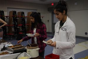 Junior Rhea Nandra checks payments. Nandra is a part of junior Nandhana Nair's group, which sold pasta with a variety of toppings.