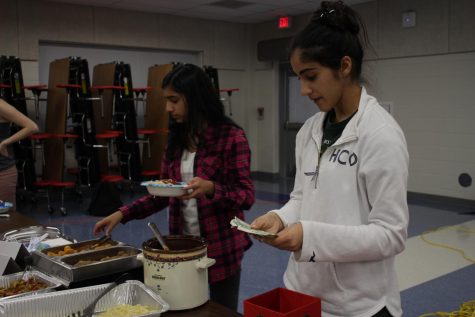 Junior Rhea Nandra checks payments. Nandra is a part of junior Nandhana Nair's group, which sold pasta with a variety of toppings.