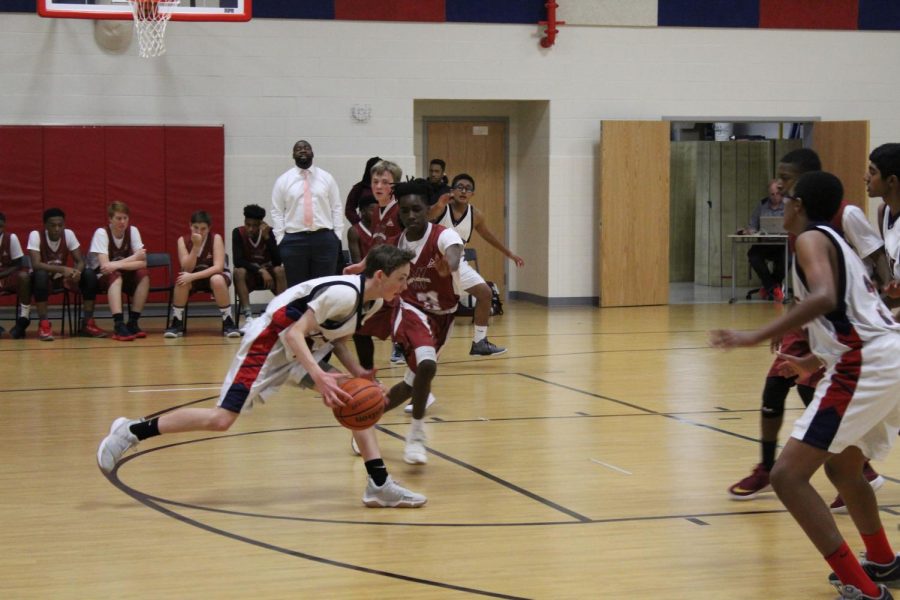 Tightly guarded by the defender and nowhere to pass to, starting point guard Ian Gresenz drives in for a layup. After the losing their early lead in the first quarter, the team was determined to put Jefferson back in the lead.