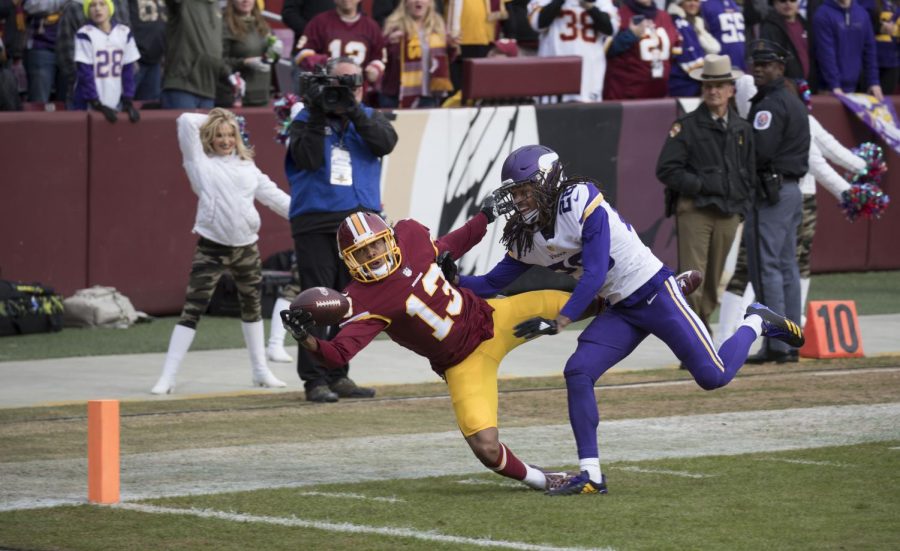 While falling, Washington wide receiver Maurice Harris makes a one-handed catch. Despite his efforts, Washington lost to the Minnesota Vikings by a score of 38-30.