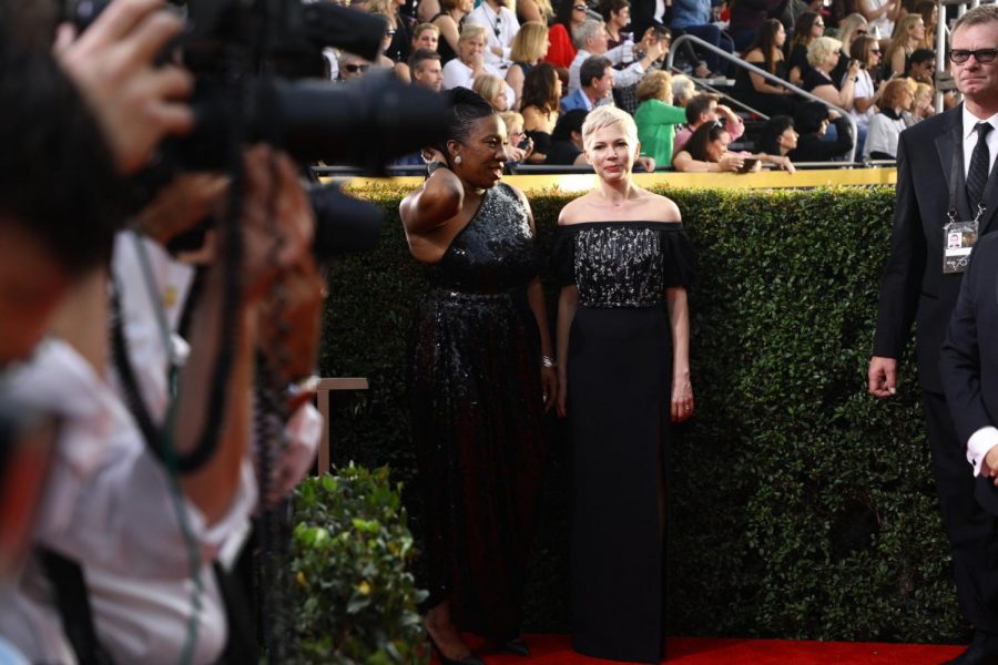 Burke, left, and Best Actress in a Motion Picture- Drama nominee Michelle Williams pose on the Golden Globes red carpet.