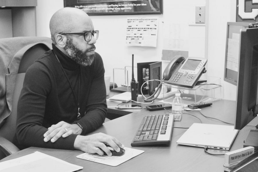 Assistant Principal Shawn Frank works in his office. Frank is the co-founder of LIFT, a program that aims to increase representation of students from low socioeconomic backgrounds.