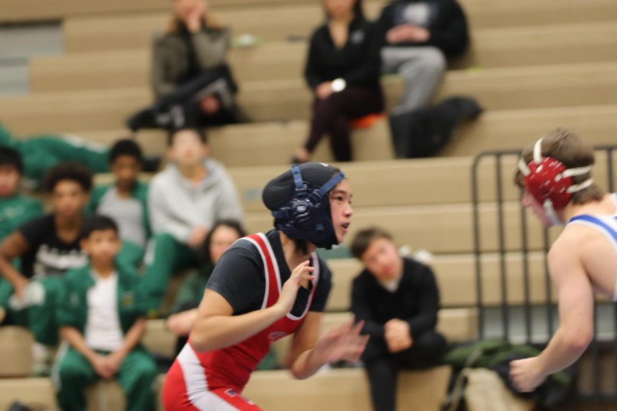 Ta faces an opponent from TC Williams during an earlier match on Jan. 31.