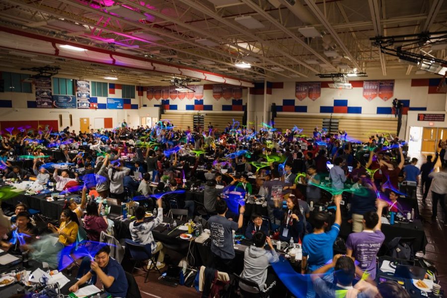 In Jeffersons main gym, students at HackTJ spin around glow-in-the-dark objects while taking a break.