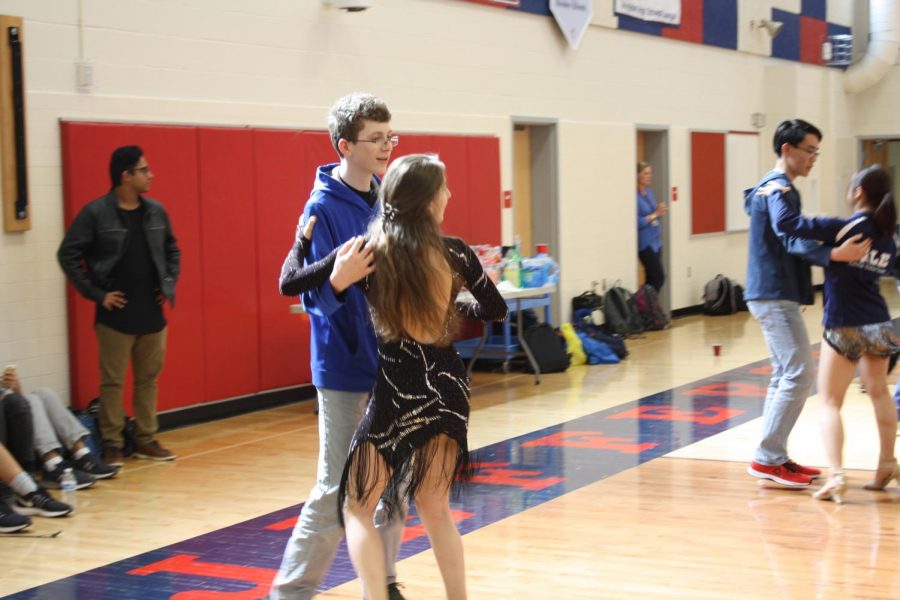 Junior Ruben Ascoli goes through the newly taught routine with a member of the Yale Ballroom Dance Team.