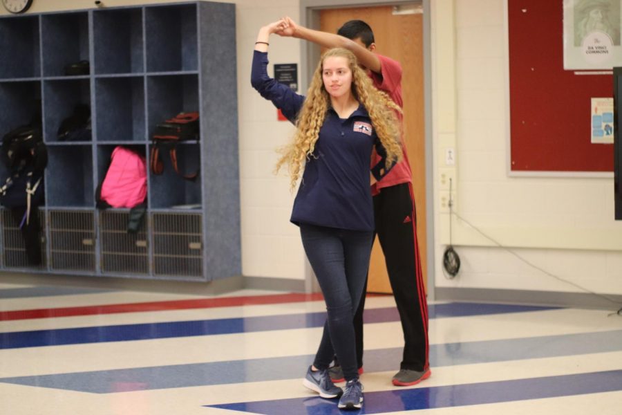 Sophomore Madelyn Khoury and  sophomore Atharva Haldankar practice the Hammerlock Turn.