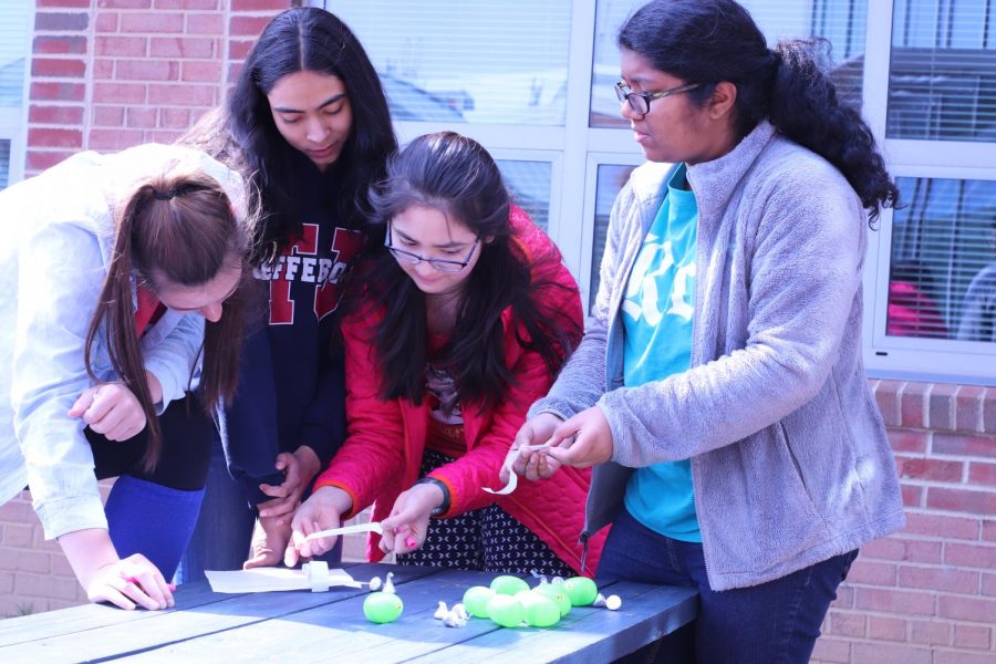 Discussing possible answers to the culture questions, Victoria Graf and her group mates try their best to crack the code.
