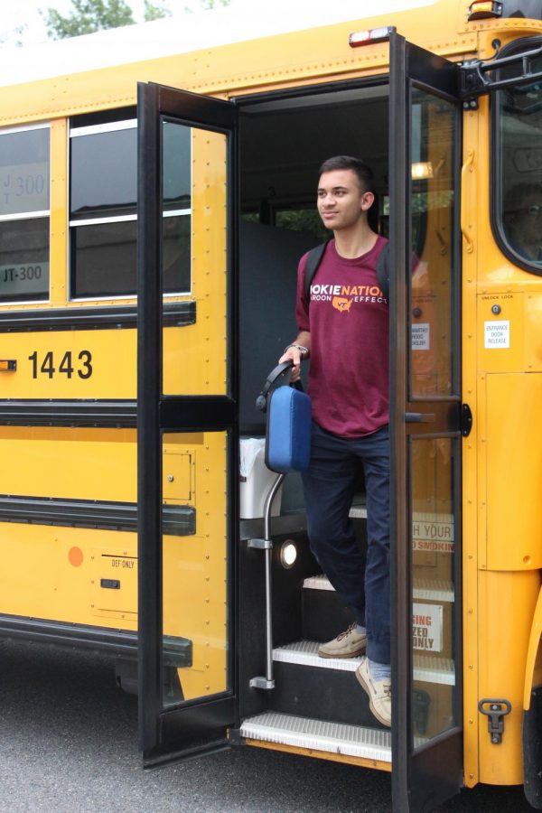 Senior Dheeraj Jassal exits his bus depot. With the elimination of neighborhood stops, Jassal is now forced to travel for a longer period of time daily.