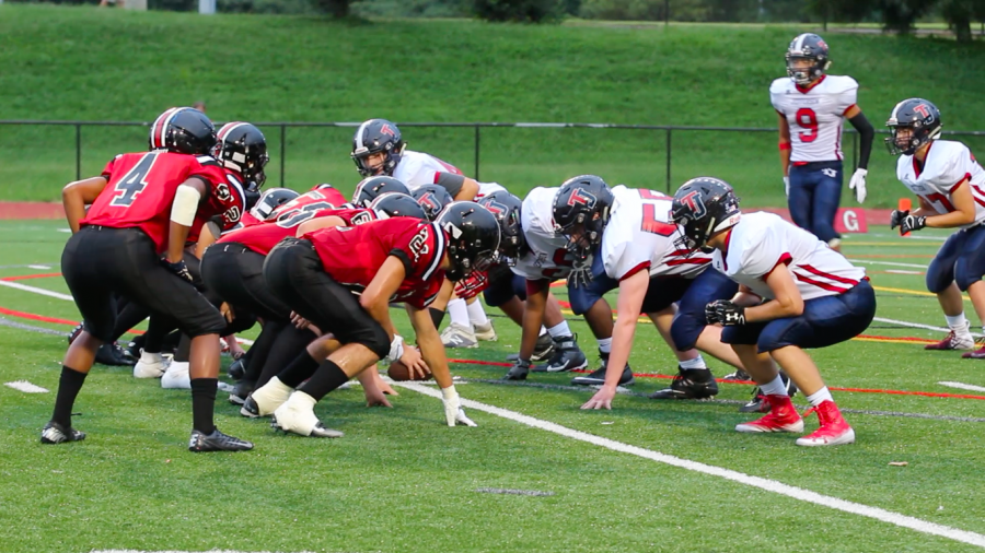 The Colonials and Mustangs wait for the play to start during their game on Aug 30th.