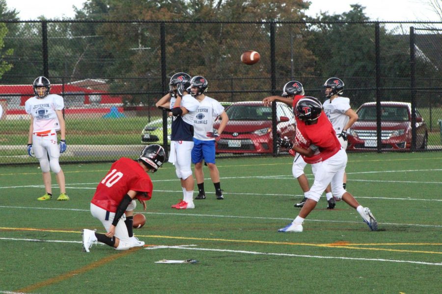 Having lost both games in the 2018-2019 fall season and with only a week left until the varsity football team’s match against Manassas Park, starting quarterback senior Sohail Mohanty throws the ball to his wide receiver in a drill during football practice after school.