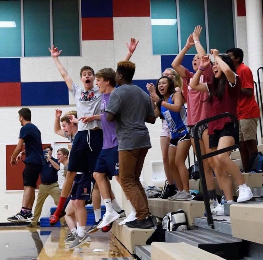 During a Jefferson volleyball home game against Marshall High School, senior Will Pemble in purple cheers as the team scores a point.