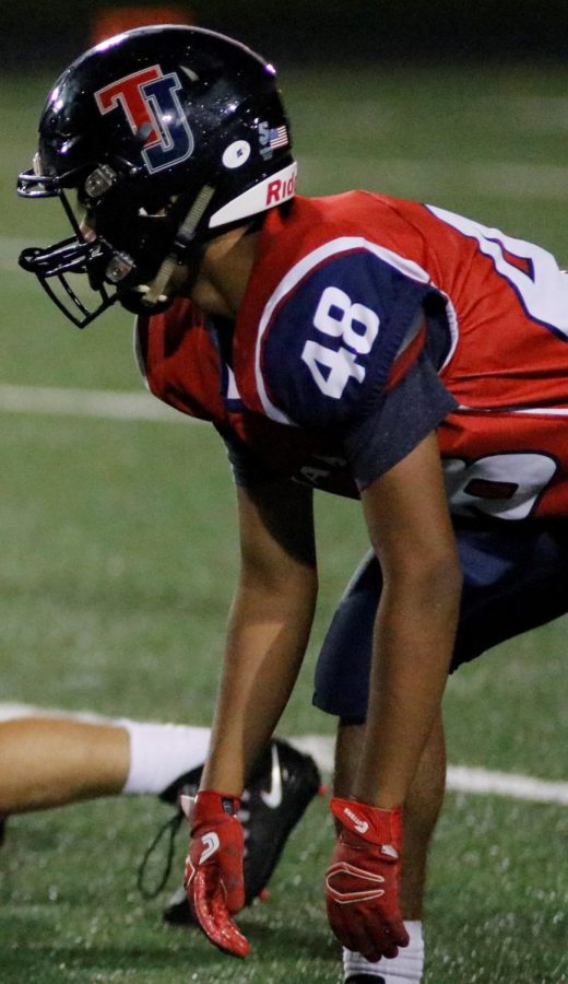 Junior Faaiz Memon steadies his stance before in preparation for a play at a Friday night home football game. Photo courtesy of Lifetouch.