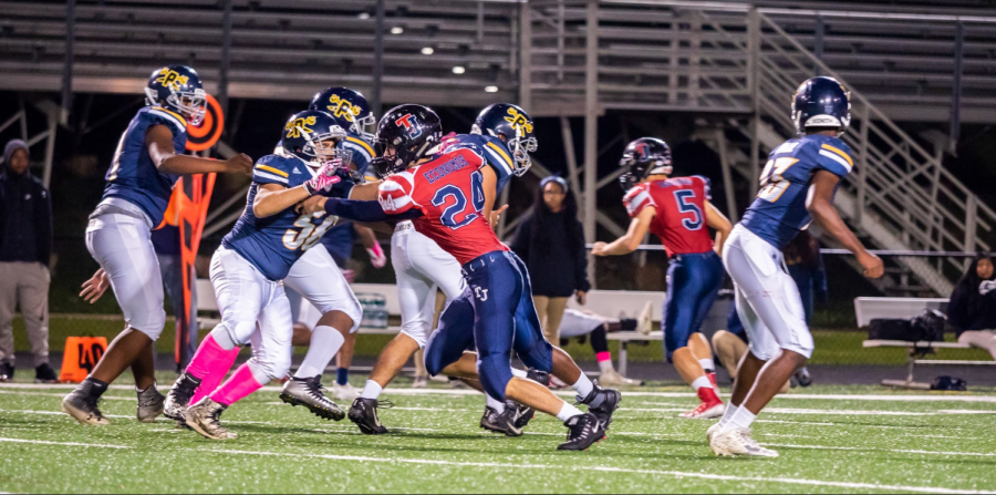 Defensive end player sophomore Niko Economos on field during the Homecoming football game.