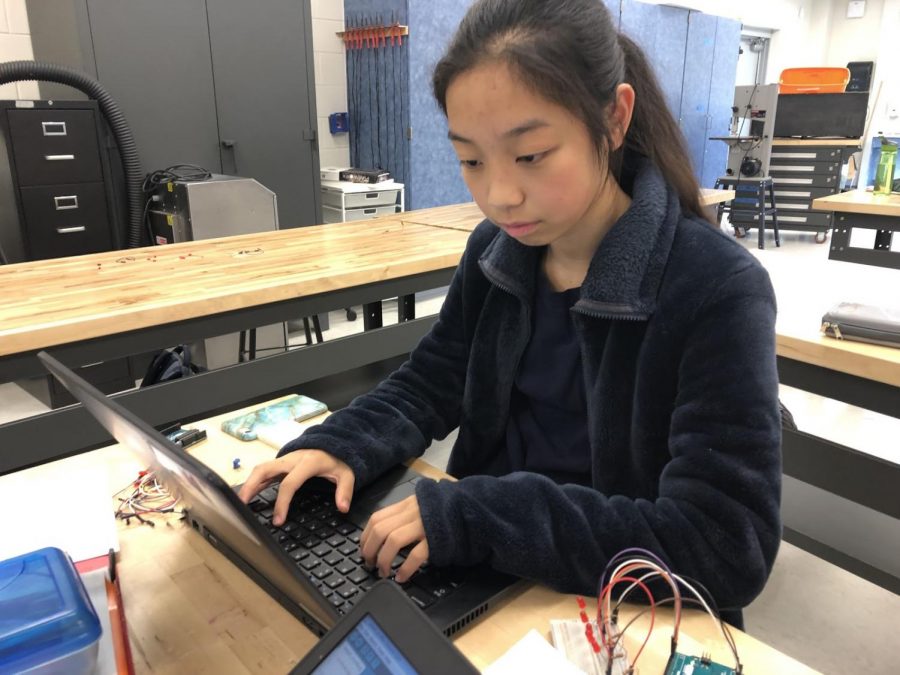 Freshman Joanna Cheng programming with an Arduino microcontroller during tech class at TJ. She was initially having difficulty trying to code a certain lab but quickly figured out the solution through determination.