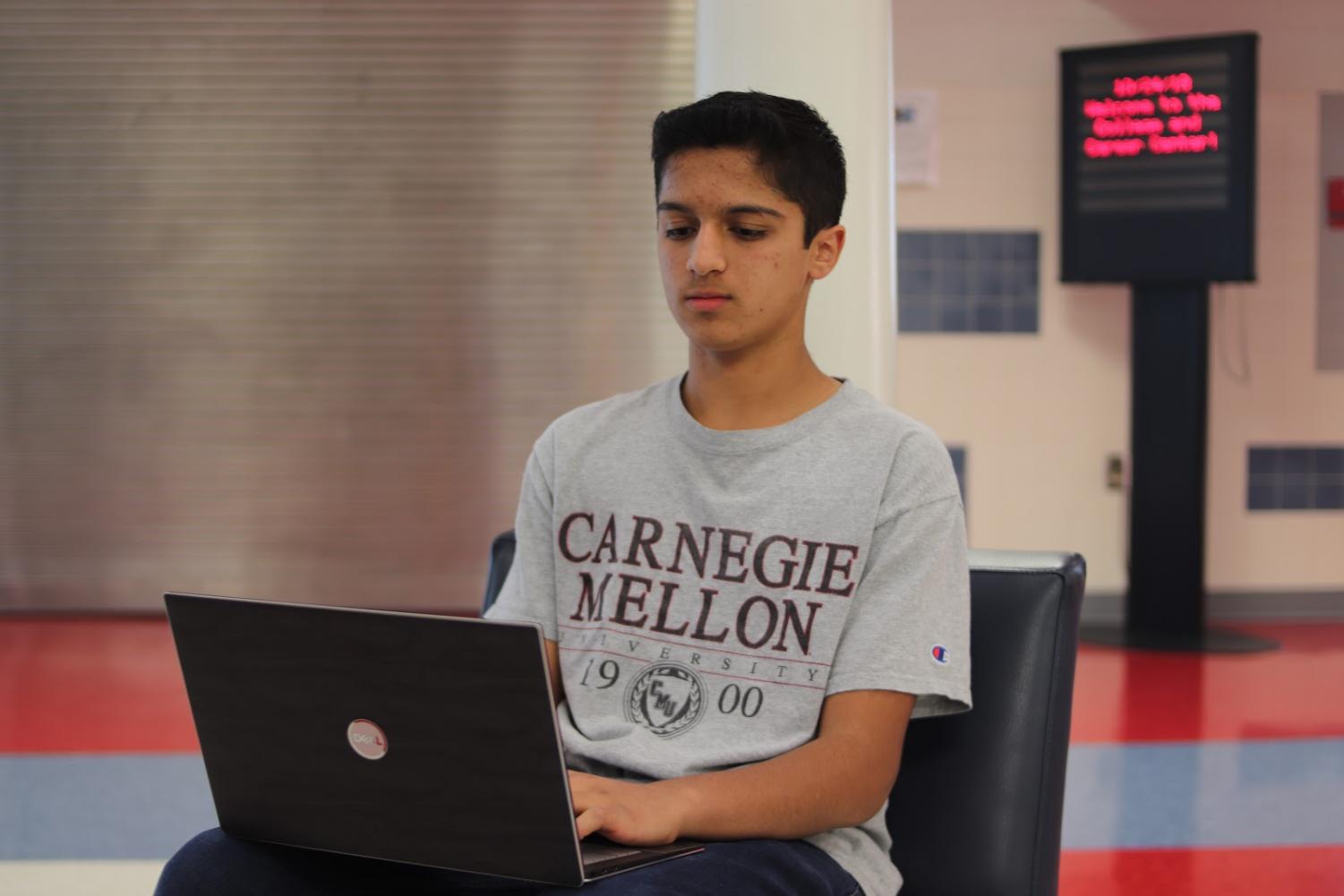 Akash Bhave working on improving the website for Single Mothers United, one of the many nonprofits his company has helped. In the future, Bhave hopes to work with more commercial clients.