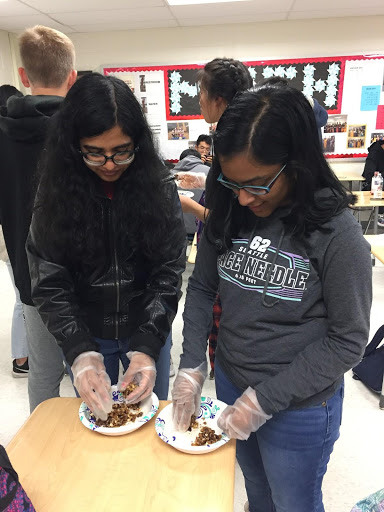 Sweta Parajuli and Trishya Pagadala make the sugar plums by combining a nut mixture with honey, cinnamon, cardamom and salt. Photo courtesy of Vegetarian Society.