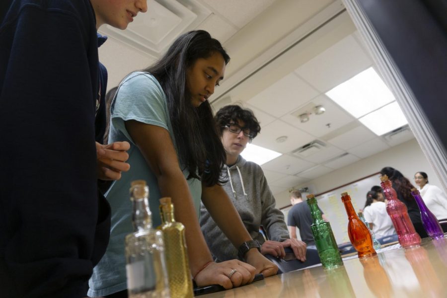 Freshman Isha Patel and a group of other club members work fast to solve the tricky puzzle in front of them during a trial run of one of the escape rooms. They check for any errors, mistakes, or any difficulties in playing the game.