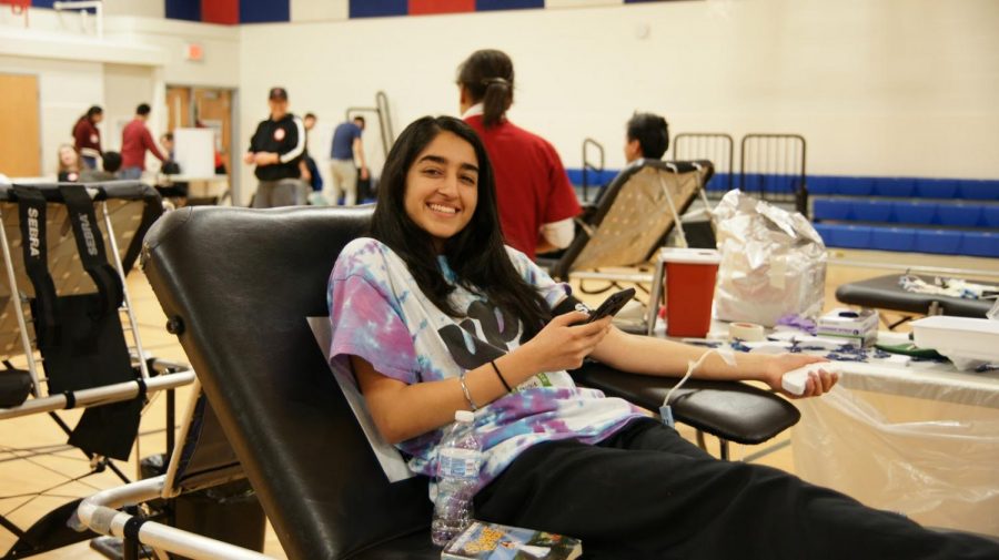 Laying on a couch, junior Khushie Matharoo gets her blood drawn at the annual Red Cross Blood Drive. “I loved talking with the phlebotomists and having fun with them, although they did have to poke both my arms to find blood.”