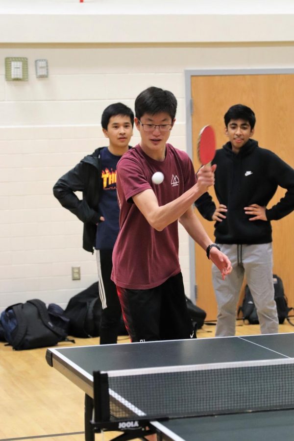 Ready+for+action%2C+freshman+Andrew+Kim+attempts+to+knock+back+the+ball+coming+at+him.+Freshman+Shreyas+Chennamaraja+and+Alex+Peal+watch+in+the+background+as+they+wait+for+their+match+to+begin.+Photo+courtesy+of+Forrest+Meng.