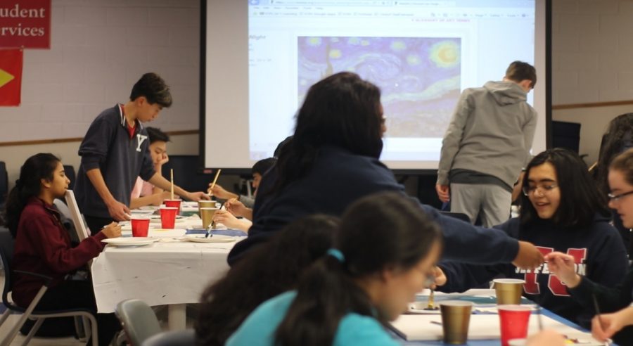 Students paint on different canvases, inspired by the artwork of previous artists, such as the “Starry Night” painting by Van Gogh, displayed on the projector. 
