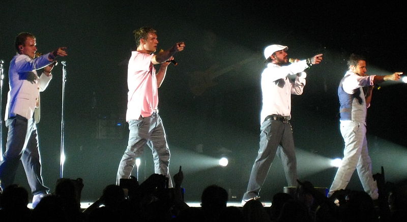 The Backstreet Boys point to the crowd at a 2008 concert.
Courtesy of Anirudh Koul through Flickr, acquired through Wikimedia Commons