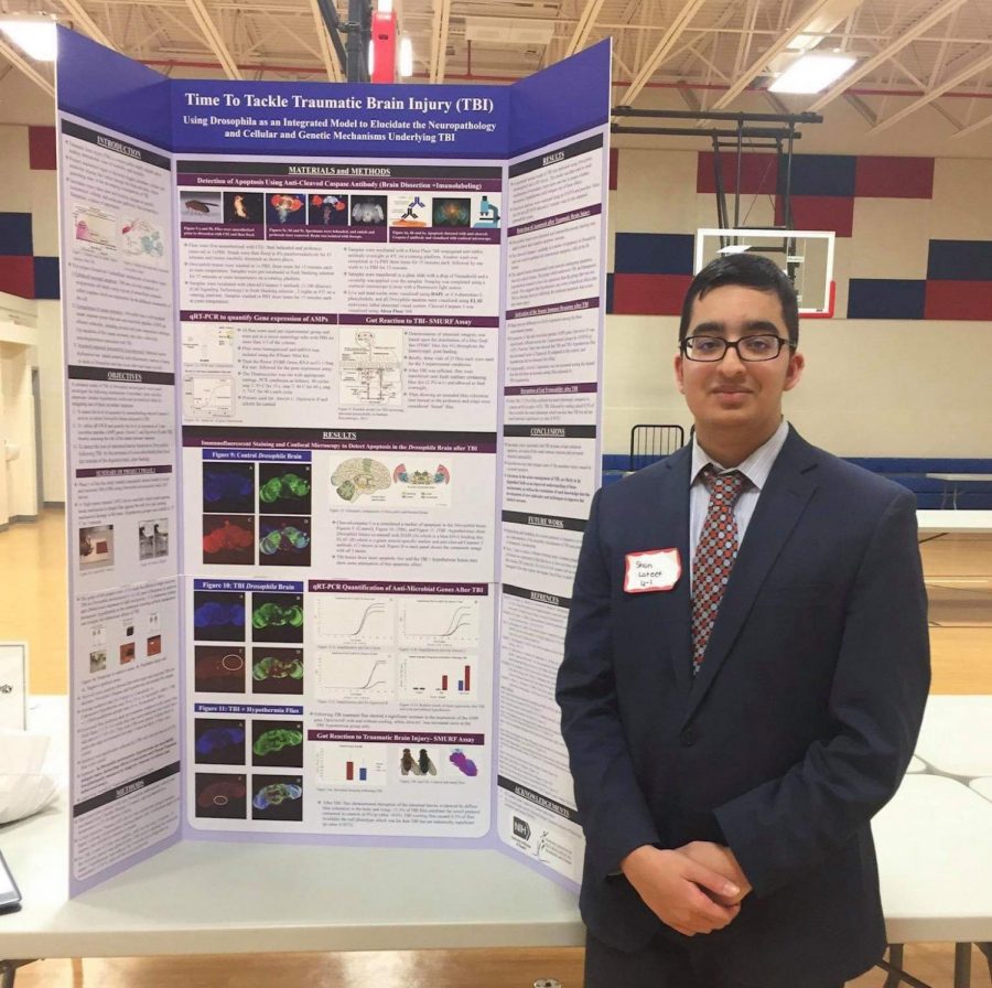 Sophomore Shan Lateef poses in front of his board at this years Jefferson Science Fair