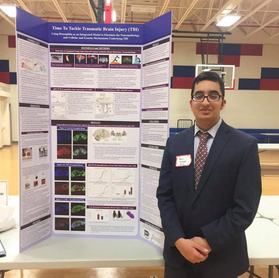 Sophomore Shan Lateef poses in front of his board at this year's Jefferson Science Fair