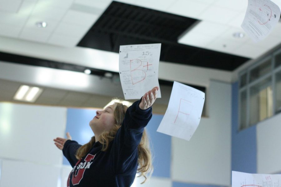 Freshman, Claire Wilson stands in Nobel Commons as she is showered with graded papers. Grades are an integral part of student life at Jefferson, but sometimes they don’t always go our way (as seen in the picture). In those cases, is it alright to ask for a grade bump?