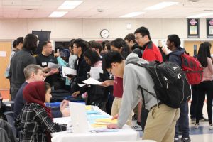 Junior Adam Yao discusses possible summer opportunities with representatives from various companies, such as Yext, during the Internship Fair. The fair is designed to aid students in finding summer opportunities to expand their knowledge and explore their career.