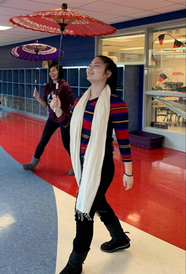 Junior Zhejia Yang, front, and Senior Cynthia Zhang, back, twirl their yosakoi umbrellas while practicing for their onstage performance.